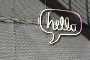 Neon sign saying "hello" in a quote bubble